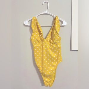 yellow swimsuit with white polka dots and tie sleeves